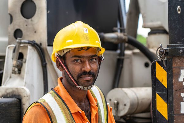 migrant worker with hard hat